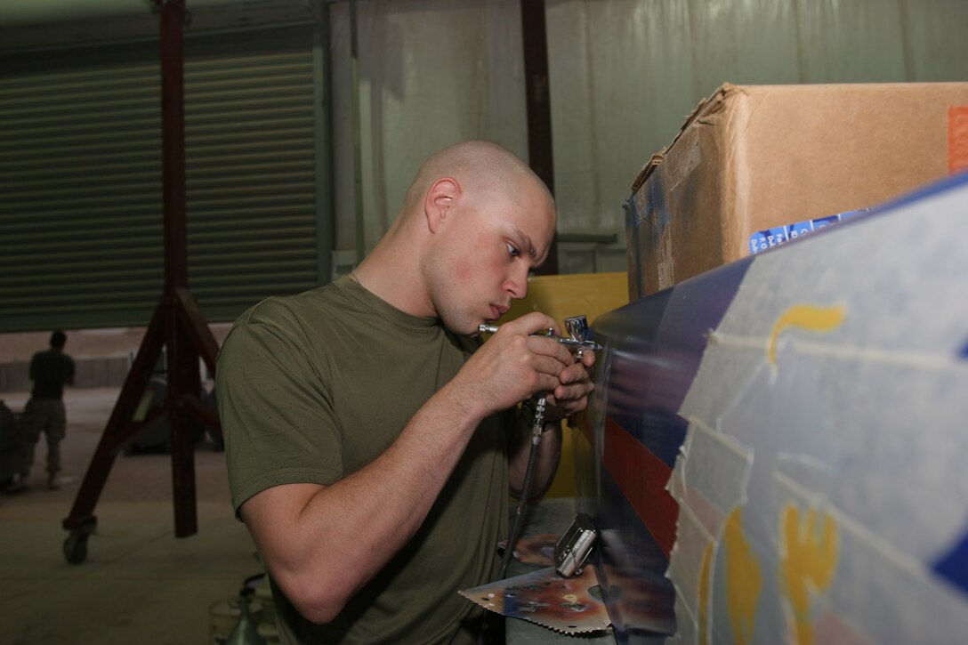 AL ASAD, Iraq - Corporal Douglas Brown, an F/A-18 Hornet mechanic with Marine Aviation Logistics Squadron 26 and Mableton, Ga., native, adds some depth to an aircraft on his latest work of art. Brown has been an airbrush artist for eight years.