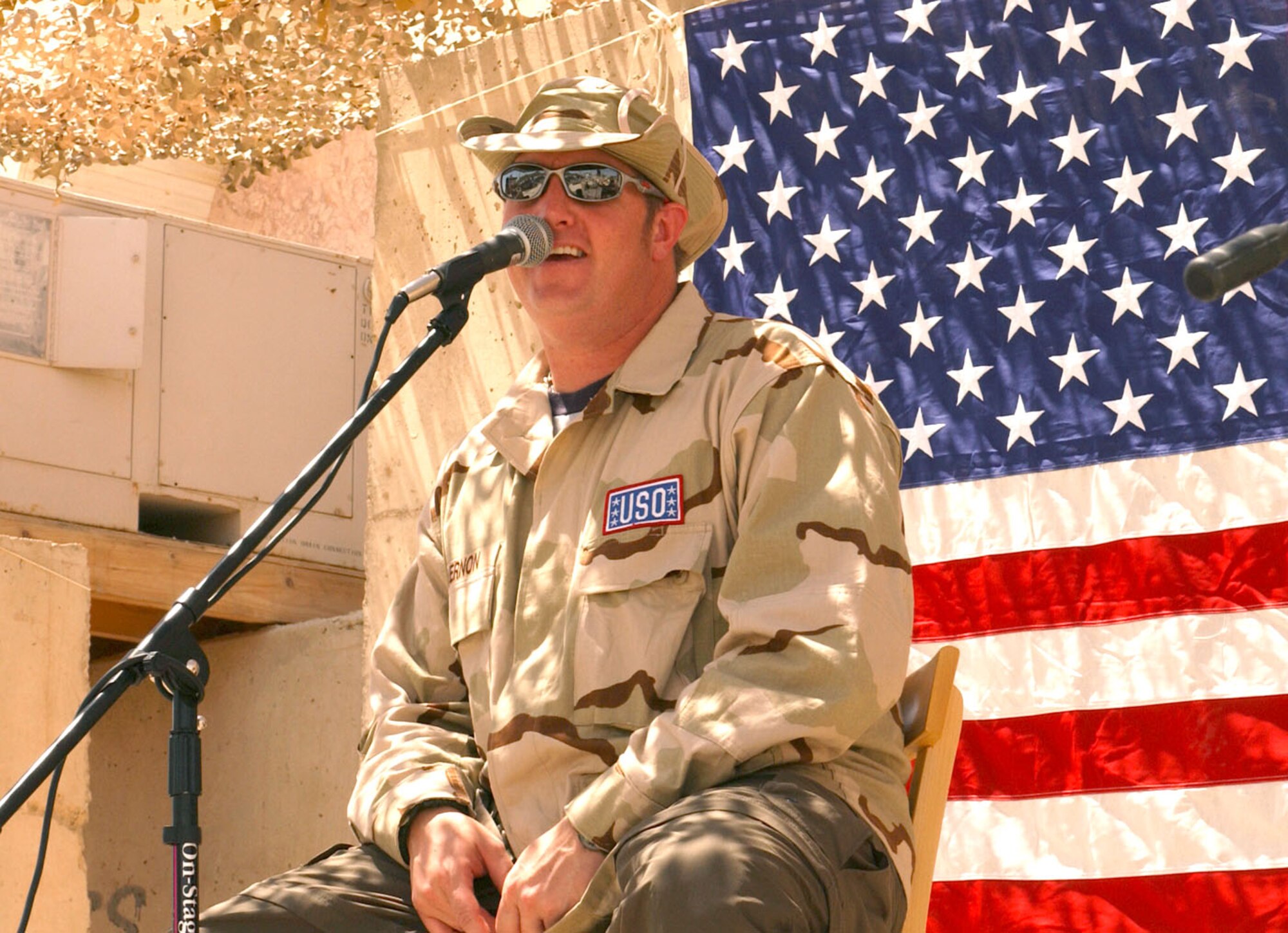 BAGHDAD, Iraq -- Gary LeVox, lead singer for country music group Rascal Flatts, performs for Airmen and Soldiers at Baghdad International Airport on Aug. 5 from a make-shift stage behind a building that was once Saddam Hussein's military base operations facility.  The group was here as part of a United Services Organization tour.  (U.S. Air Force photo by Tech. Sgt. Brian Davidson)