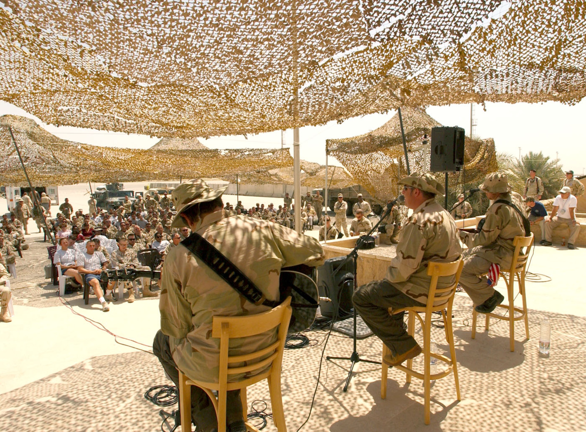 BAGHDAD, Iraq -- Country music group Rascal Flatts performs for Airmen and Soldiers at Baghdad International Airport on Aug. 5 from a make-shift stage behind a building that was once Saddam Hussein's military base operations facility.  The group was here as part of a United Services Organization tour.  (U.S. Air Force photo by Tech. Sgt. Brian Davidson)
                               