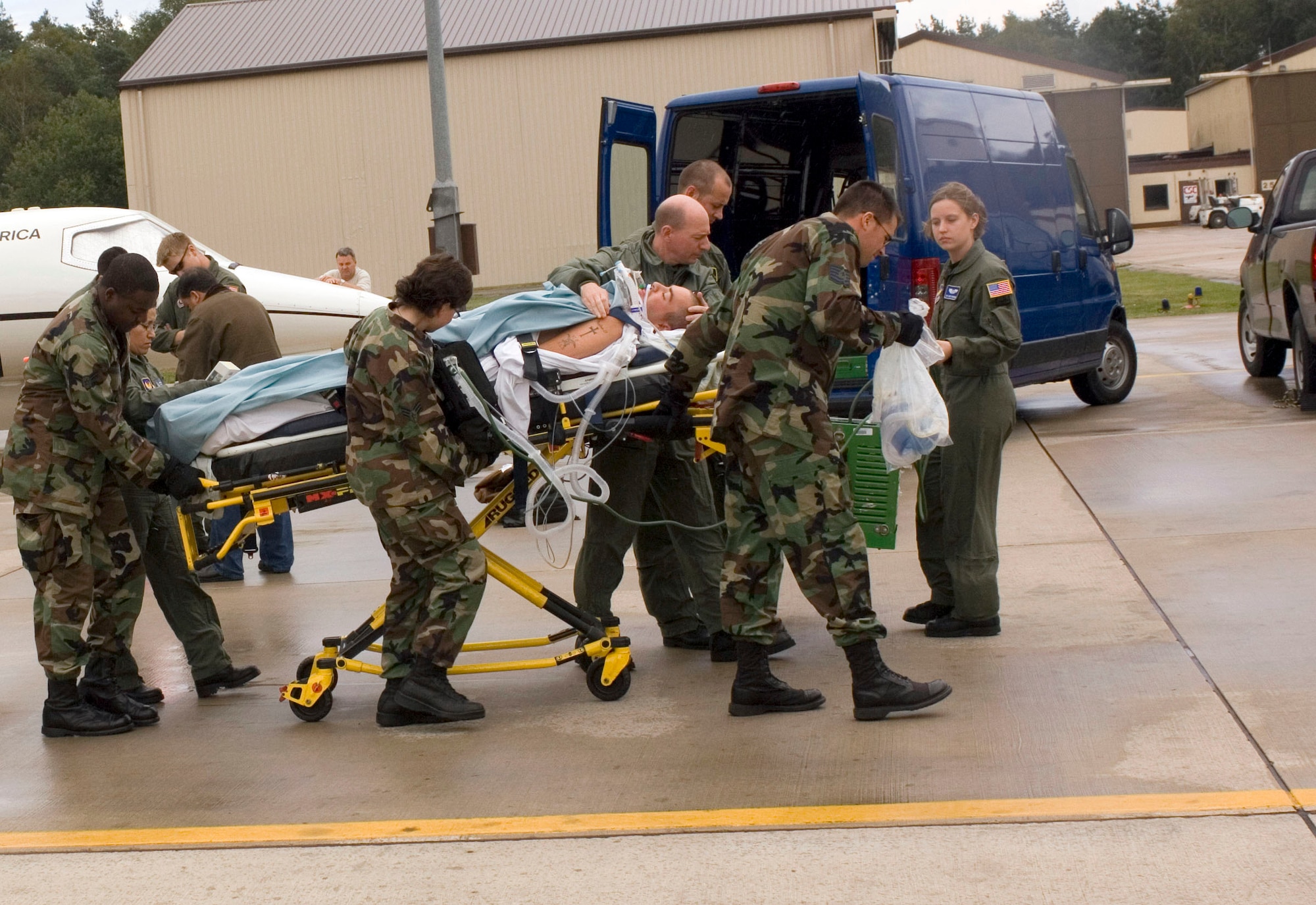 RAMSTEIN AIR BASE, Germany -- Doctors, nurses and medical technicians rush a critically ill patient to an awaiting ambulance. Airmen with the 435th Contingency Aeromedical Staging Facility here work with medical teams from nearby Landstuhl Regional Medical Center to transport and care for servicemembers in Iraq and Afghanistan. The staging facility team also coordinates the movement of patients to stateside hospitals. (U.S. Air Force photo by Master Sgt. John E. Lasky)
