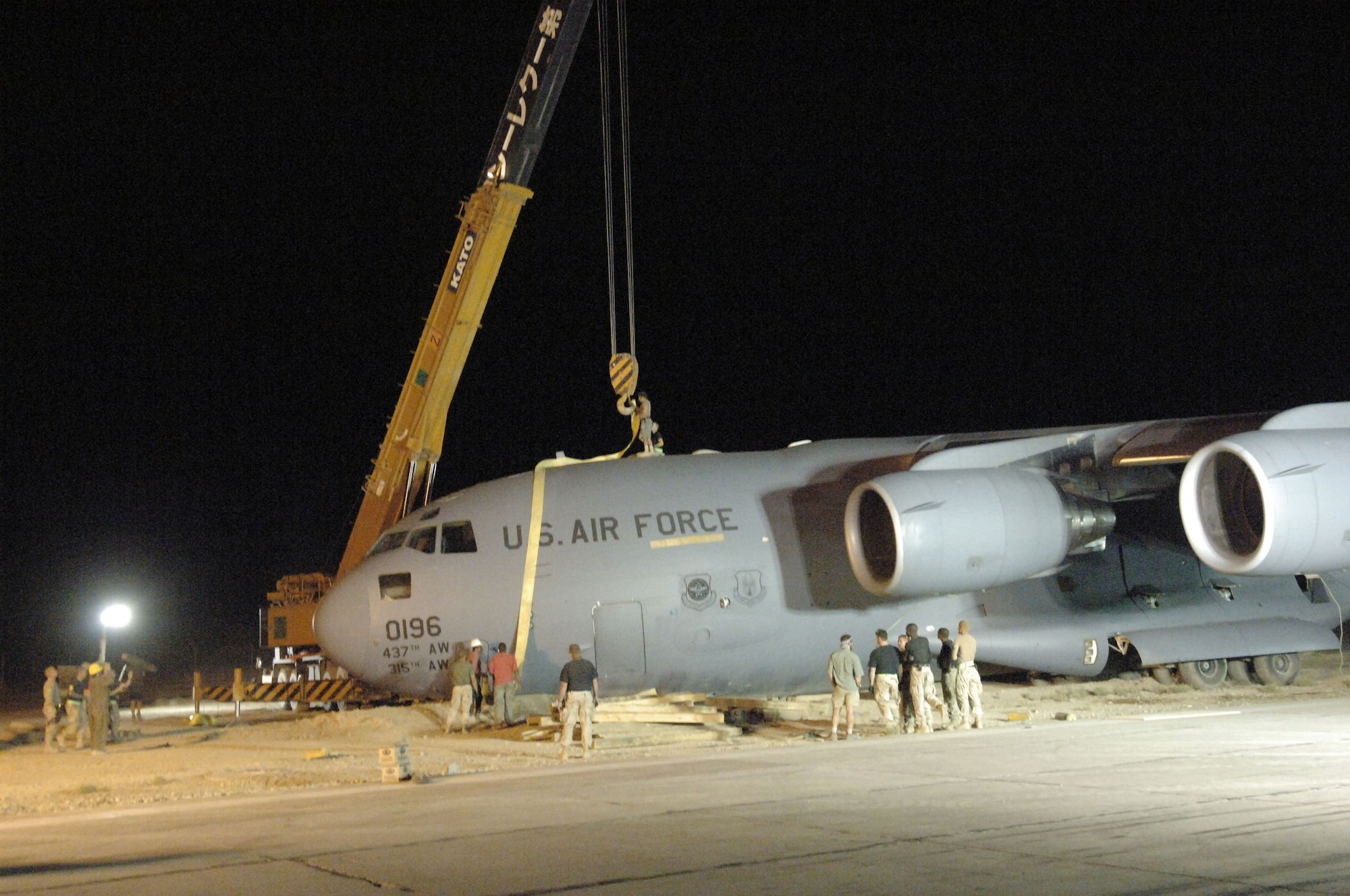 BAGRAM AIR BASE, Afghanistan -- Airmen and Soldiers join forces to move a C-17 Globemaster III that ran off the runway Aug. 6. The runway was temporarily closed, but was fully active again in less than 30 hours. (U.S. Air Force photo by Capt. Mark D. Gibson)