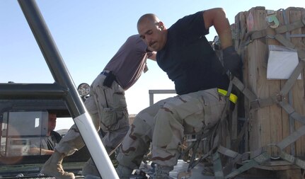 BAGRAM AIR BASE, Afghanistan -- Tech. Sgt. Martin Zamora gives a pallet of munitions a push from a 60K loader onto a high-line dock during a recent delivery here. He is assigned to the 455th Expeditionary Logistics Squadron and is deployed from Charleston Air Force Base, S.C. (U.S. Air Force photo by Capt. Mark D. Gibson) 

