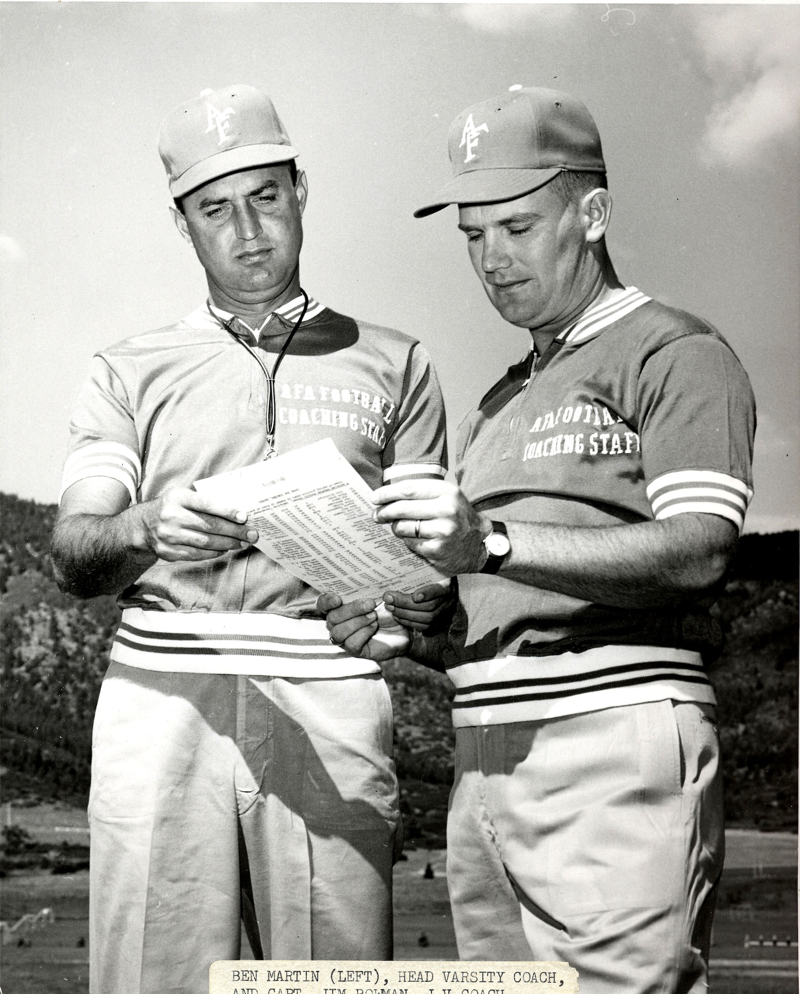 U.S. AIR FORCE ACADEMY, Colo. -- Falcon head coach Ben Martin (left) and Jim Bowman check the roster sheet in this 1961 photo.  Mr. Bowman has been with the academy for 48 years. (U.S. Air Force photo)
