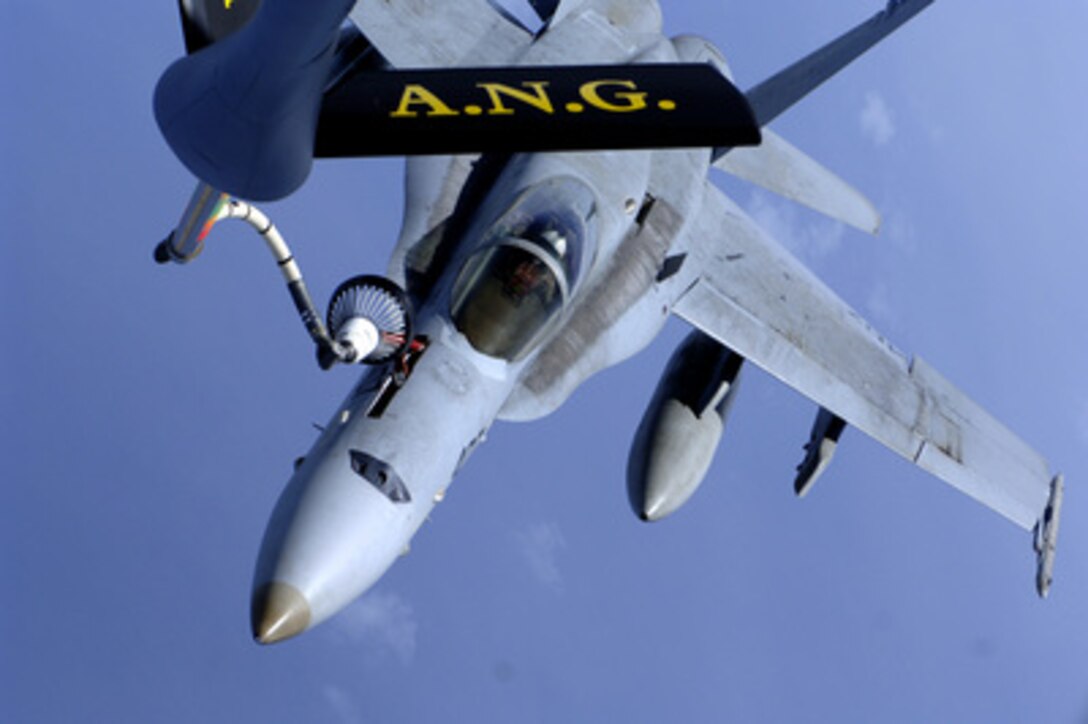 An F/A-18 Hornet from the aircraft carrier USS Kitty Hawk (CV 63) receives fuel from a U.S. Air Force KC-135R Stratotanker during an aerial refueling mission over the Pacific Ocean on Aug. 2, 2005. The Stratotanker is assigned to the 186th Air Refueling Wing, which is deployed to Andersen Air Force Base, Guam, in order to provide air-to-air refueling between distant locations. 