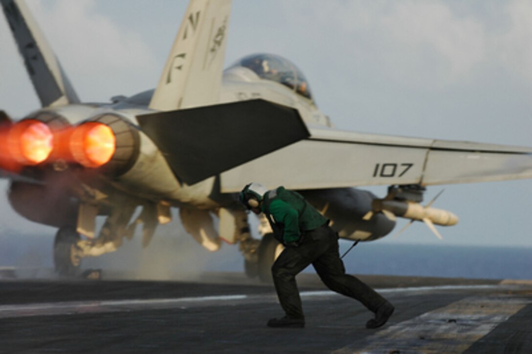 A waist catapult operator runs out after the launch of an F/A-18F Super Hornet to ready Catapult No. 3 for aircraft recovery on the flight deck of USS Kitty Hawk (CV 63) during the Joint Air and Sea Exercise on Aug. 8, 2005. The USS Kitty Hawk Carrier Strike Group and the amphibious assault ship USS Boxer (LHD 4) are participating in the third annual Joint Air and Sea Exercise 2005 with the U.S. Air Force and Marine Corps in the western Pacific Ocean. The exercise focuses on integrated joint training proficiency in detecting, locating, tracking, and engaging units at sea, in the air, and on land. 