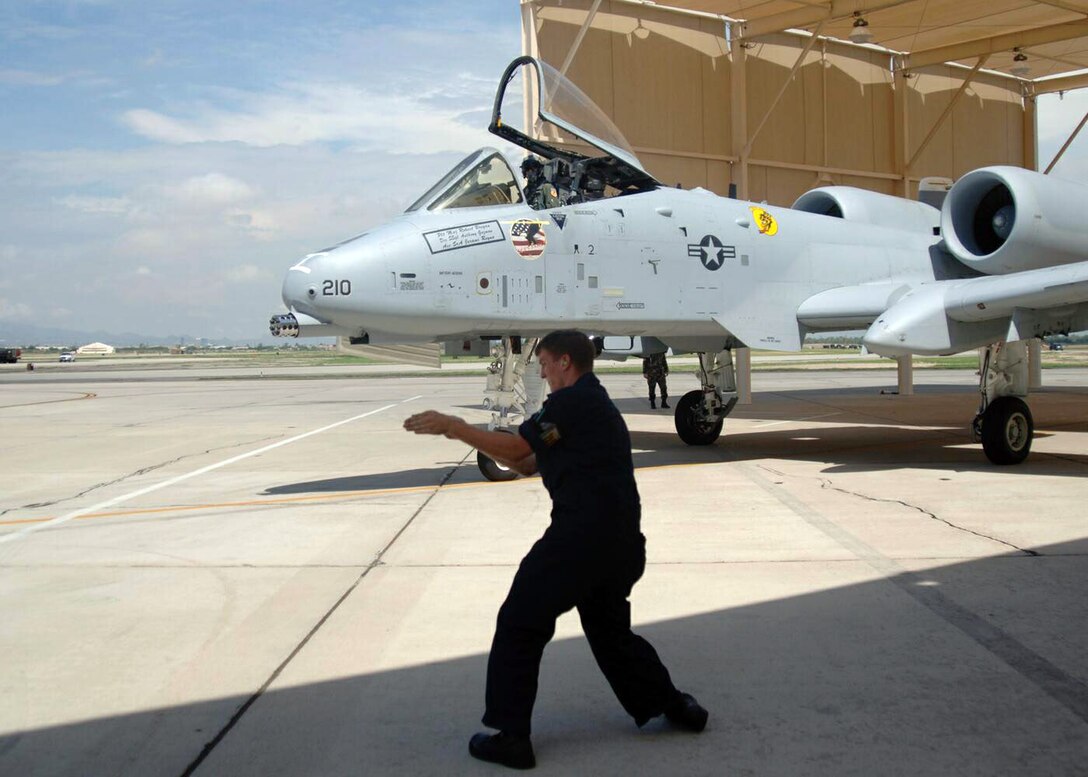 DAVIS-MONTHAN AIR FORCE BASE, Ariz. -- Airman 1st Class Tyler Young waves on Maj. Rob Brogan as he prepares for takeoff in an A-10 Thunderbolt II.  Major Brogan is a West Coast demonstration team pilot assigned to the 355th Operations Group here. Airman Young is assigned to the 355th Aircraft Maintenance Squadron.  (U.S. Air Force photo by Airman 1st Class Christina D. Ponte) 