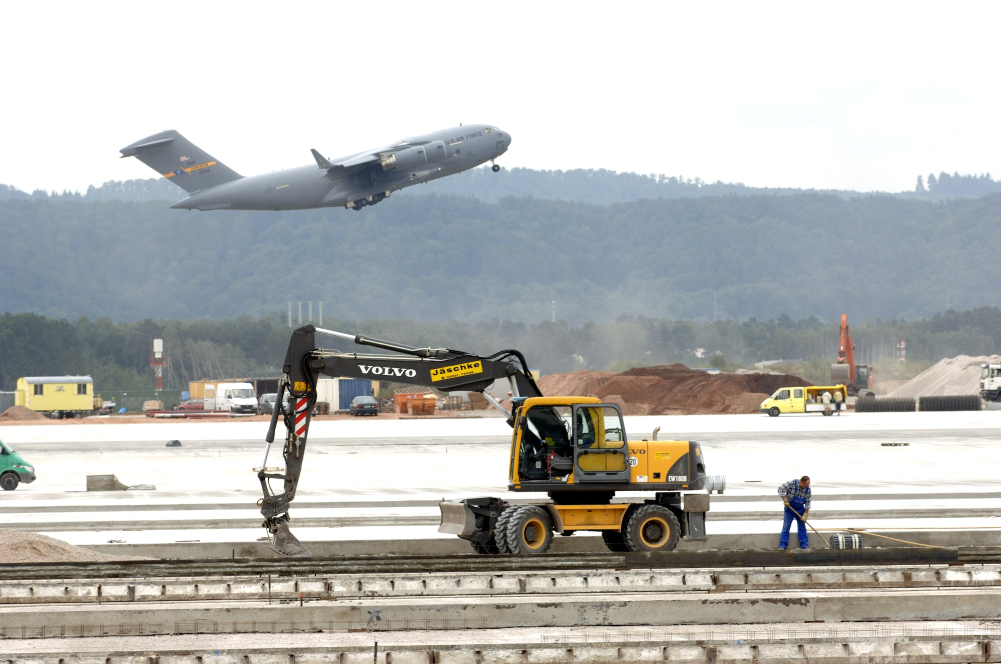 RAMSTEIN AIR BASE, Germany -- A C-17 Globemaster III from Charleston Air Force Base, S.C., takes off from here on a return flight home.  Ongoing construction on the parking ramp, part of the Rhein-Main Transition Program, will make Ramstein the new "Gateway to Europe" when Rhein-Main Air Base closes in December.  (U.S. Air Force photo by Master Sgt. John E. Lasky)