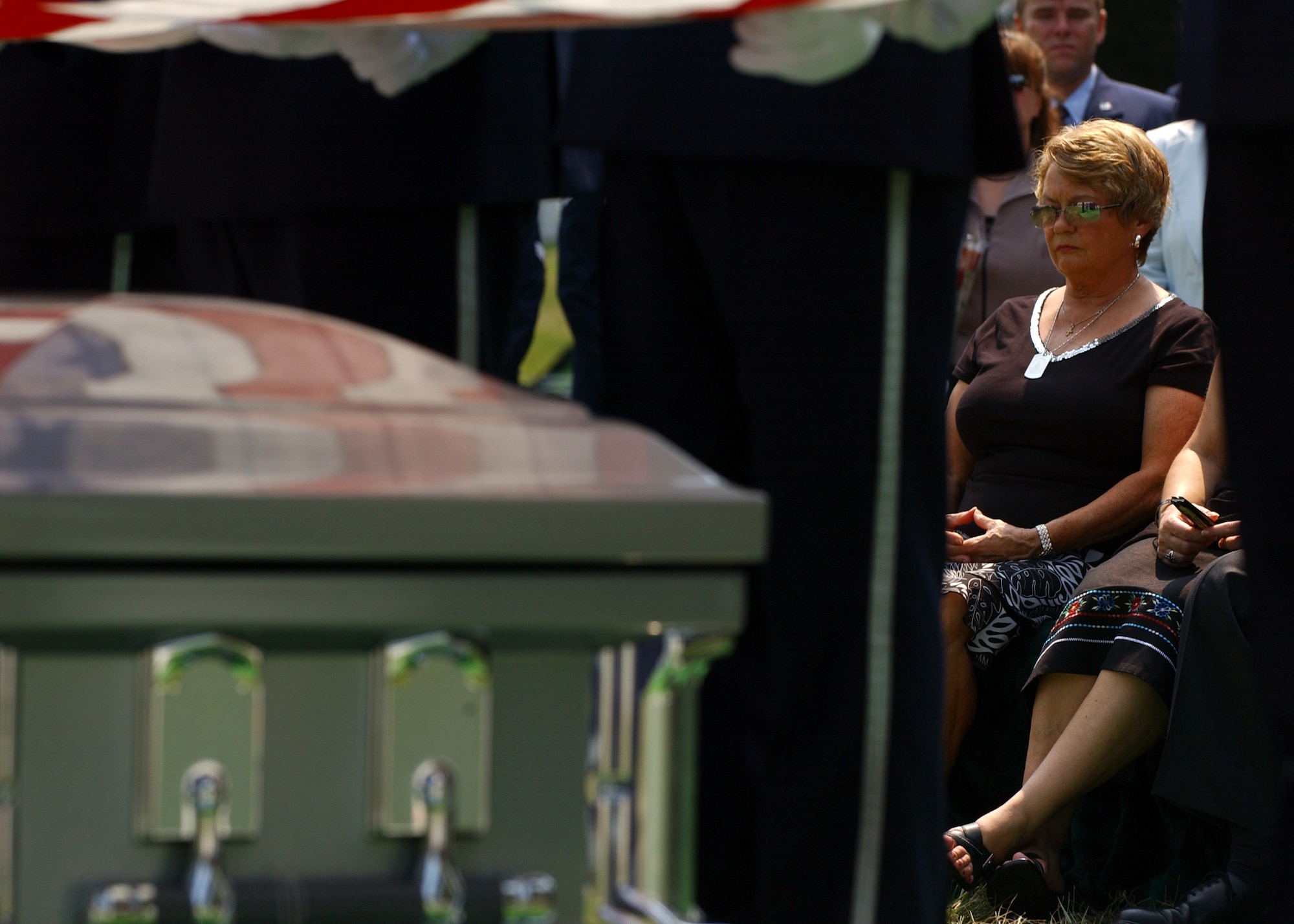 ARLINGTON NATIONAL CEMETERY, Va. -- Linda Crate, mother of Staff Sgt. Casey Crate, reflects during the Aug. 11 funeral held here for her son and three other U.S. Airmen and an Iraqi Airman who died May 30 in an aircraft accident in Iraq. (U.S. Air Force photo by Staff Sgt. Amber K. Whittington) 