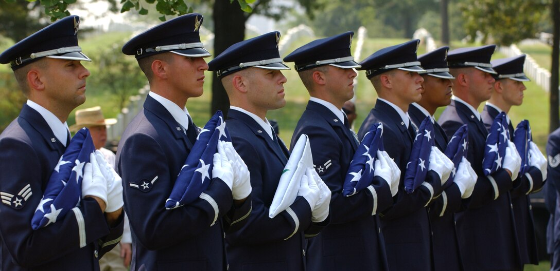 ARLINGTON NATIONAL CEMETERY, Va. -- Honor guard Airmen hold flags to be presented to the families of four U.S. Airmen and an Iraqi Airman who died May 30 in an aircraft accident in Iraq. (U.S. Air Force photo by Staff Sgt. Amber K. Whittington)