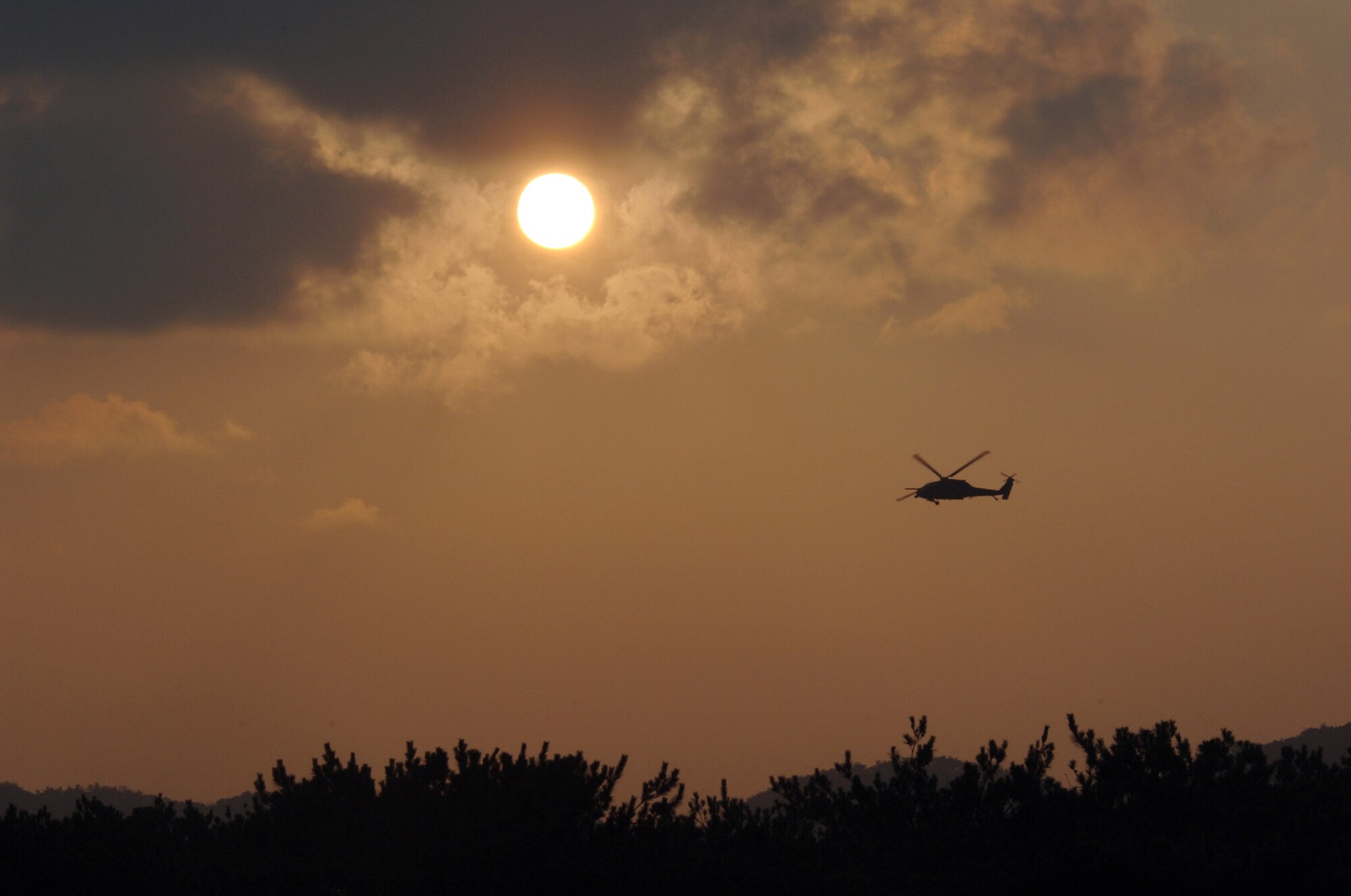 KADENA AIR BASE, Japan -- An HH-60G Pave Hawk prepares to land during Joint Air and Sea Exercise 2005 here.  Air Force and Navy HH-60G helicopters "rescued" U.S. Embassy personnel during training. (U.S. Air Force photo by Master Sgt. Val Gempis)
