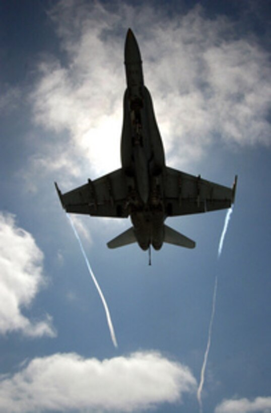 A Navy F/A-18 Hornet zooms overhead as it makes its approach for an arrested landing aboard the aircraft carrier USS Ronald Reagan (CVN 76) underway in the Pacific Ocean on Aug. 9, 2005. The Reagan is conducting carrier qualifications for the various West Coast fleet replacement squadrons. 