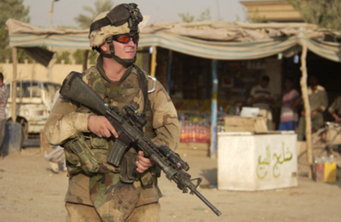 U.S. Army Spc. Daniel Firszt from Task Force 1st Battalion, 30th Infantry Regiment, 3rd Infantry Division, secures an area during a routine patrol in Muqdadiyah, Iraq, on Aug. 2, 2005. 