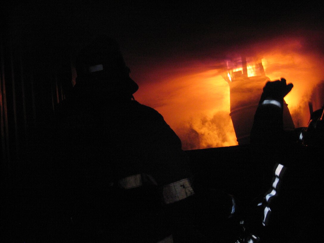 A fire rages through a training container, as cadets from the Glendale Arroyo Seco Fire Academy, Glendale, Calif., and firefighters from Marine Corps Air Station Miramar Fire Station 61 team up Aug. 14 for flashover training, an opportunity most cadets will not get from their academy.