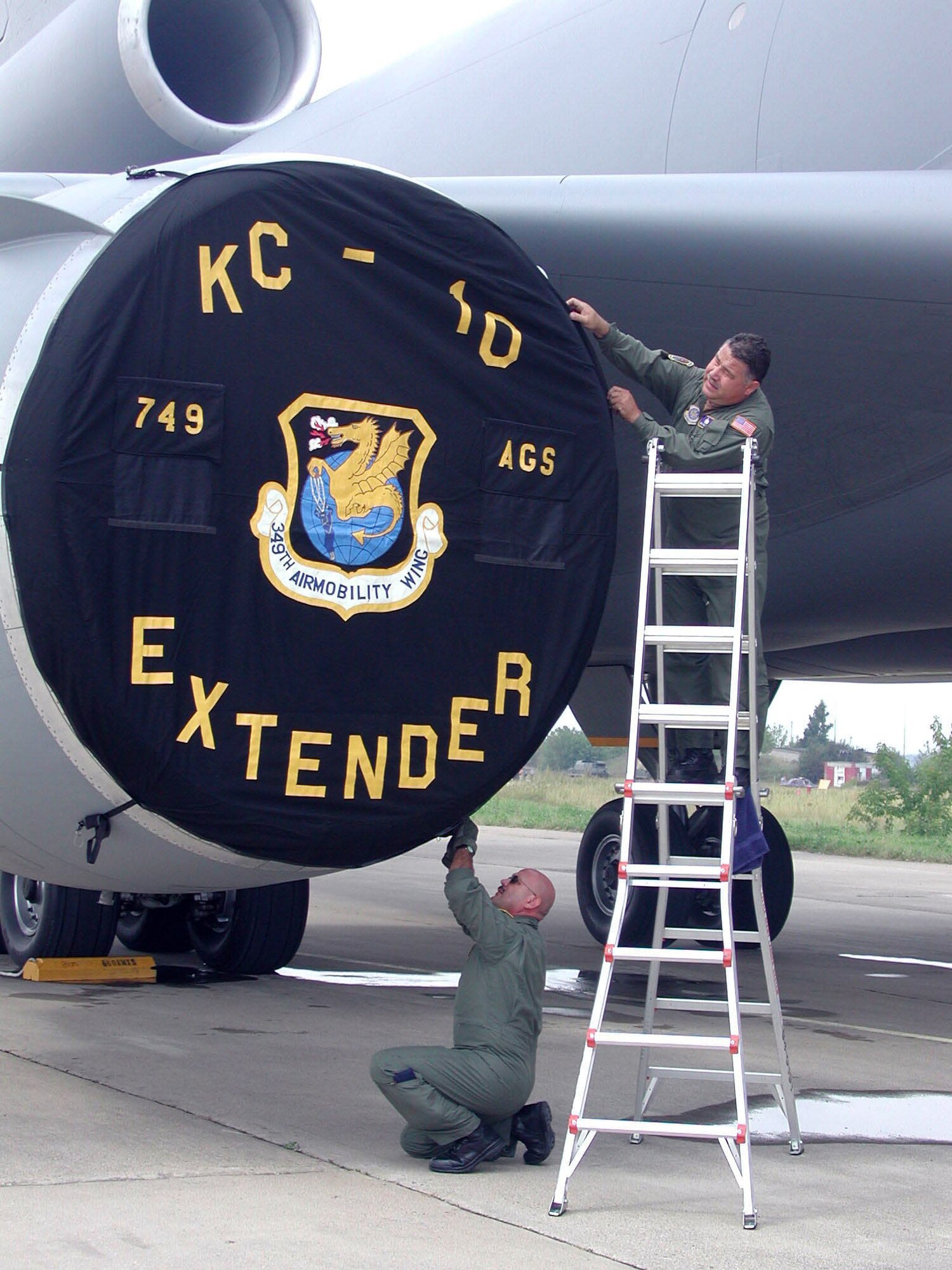 ZHUKOVSKY, Russia -- Master Sgts. Mario Andujo (left) and Raul Garcia place an engine cover on a KC-10 Extender after arriving at Ramenskoye Airfield for the Moscow International Aviation and Space Salon.  About 100 U.S. servicemembers are participatin in the air show Aug. 16 to 21.  The Airmen are crew chiefs from the 749th Aircraft Maintenance Squadron at Travis Air Force Base, Calif.  (U.S. Air Force photo by 1st Lt. Tracy Page)