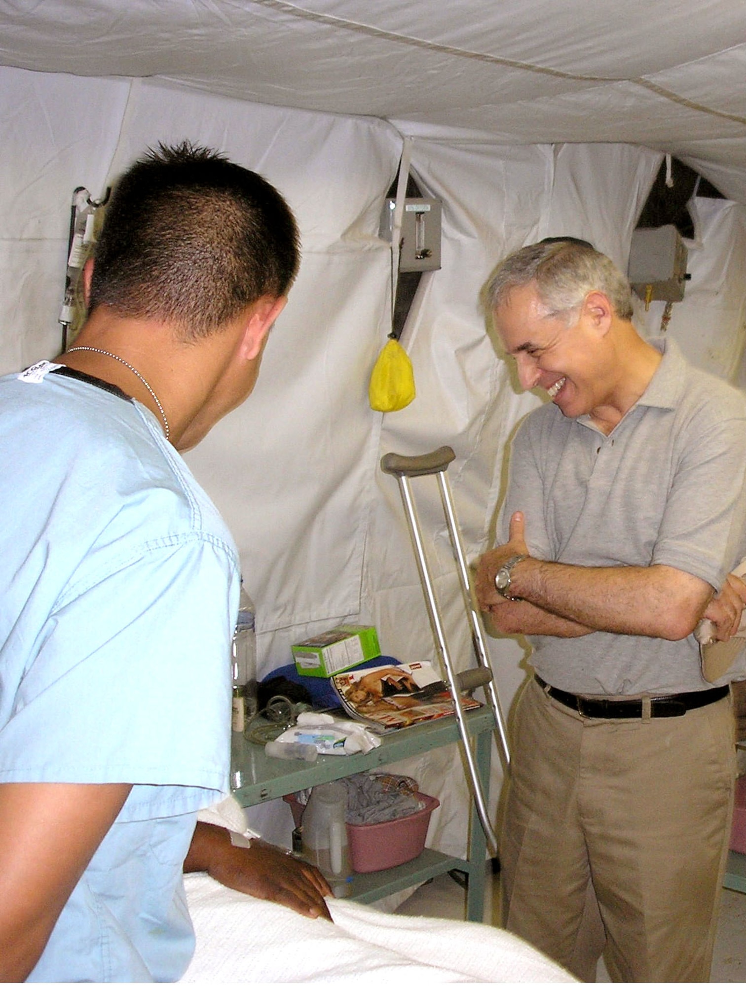 BALAD AIR BASE, Iraq -- Rabbi Arnold E. Resnicoff shares a light moment with a patient during his visit here at the Air Force Theater Hospital. (U.S. Air Force photo)
