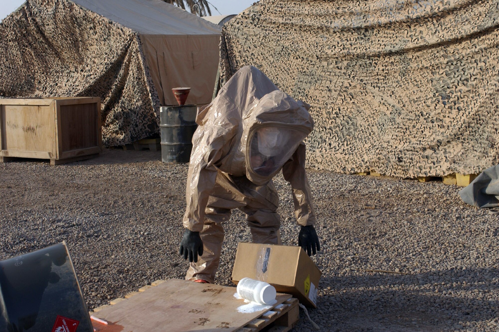 BAGHDAD, Iraq -- Airman 1st Class Matthew Metzger determines what type of simulated hazardous materials has been spilled during an exercise. He is assigned to the 447th Expeditionary Civil Engineer Squadron and is deployed from Kadena Air Base, Japan. (U.S. Air Force photo by Tech. Sgt. Brian Davidson)                             