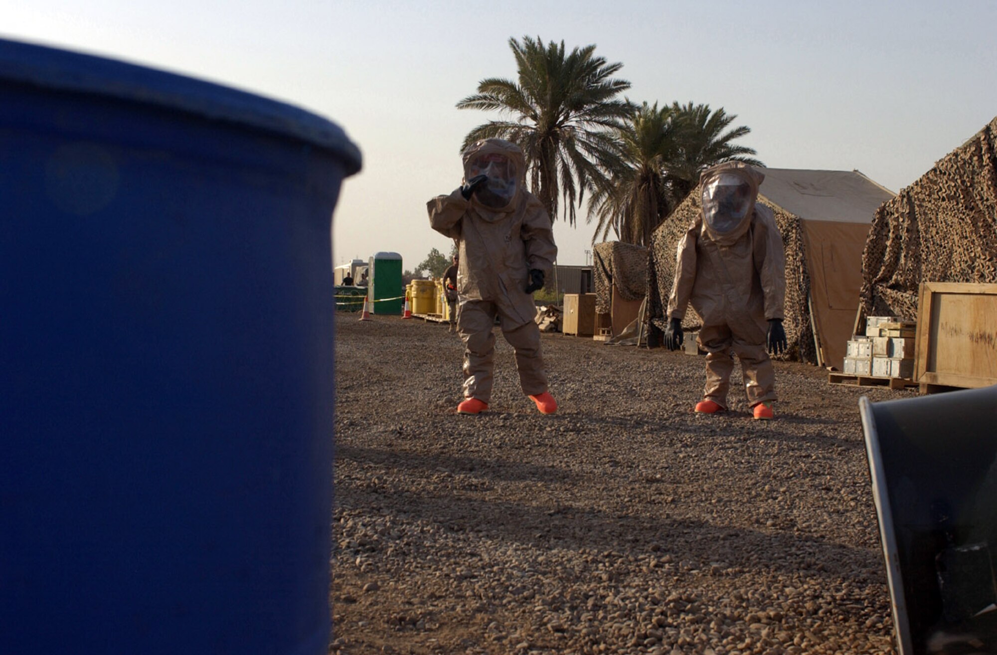 BAGHDAD, Iraq -- Staff Sgt. Spencer Proctor (left) and Airman 1st Class Matthew Metzger approach simulated hazardous materials to determine the type and nature of the threat. They are assigned to the 447th Expeditionary Civil Engineer Squadron here.  Sergeant Proctor is deployed from Luke Air Force Base, Ariz., and Airman Metzger is deployed from Kadena Air Base, Japan. (U.S. Air Force photo by Tech. Sgt. Brian Davidson)                          