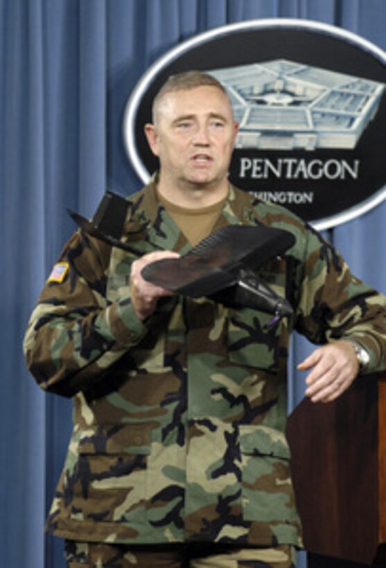 Col. Gregory N. Tubbs, U.S. Army, shows reporters a small, man-portable, remotely controlled, reconnaissance aircraft known as the Tactical Mini Air Vehicle or TACMAV during a Pentagon news briefing on Aug. 12, 2005. The rugged little plane carries two cameras and can be folded to fit into an easily carried tube. Tactical infantry units can use the plane to provide views of terrain over the next hill or of the streets of a town. Tubbs is the director of the Rapid Equipping Force, a unit whose mission involves rushing useful technologies to the war-fighters in the field. 