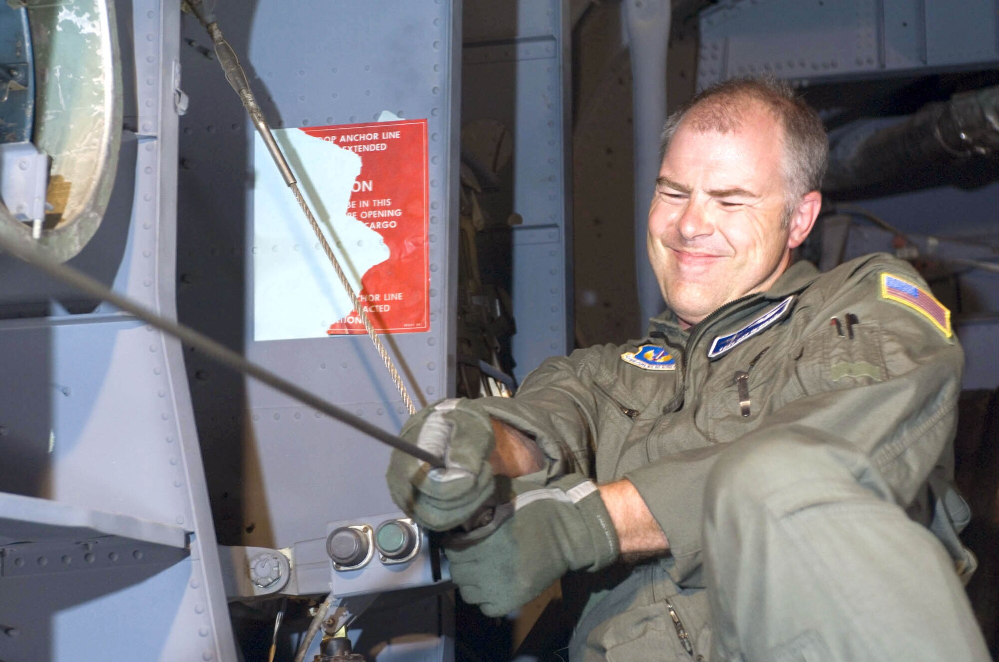 RAMSTEIN AIR BASE, Germany -- Tech. Sgt. Ray Hensley disconnects an anchor line in the rear of a C-130 Hercules. He is a loadmaster with the 37th Airlift Squadron. (U.S. Air Force photo by Master Sgt. John E. Lasky)

