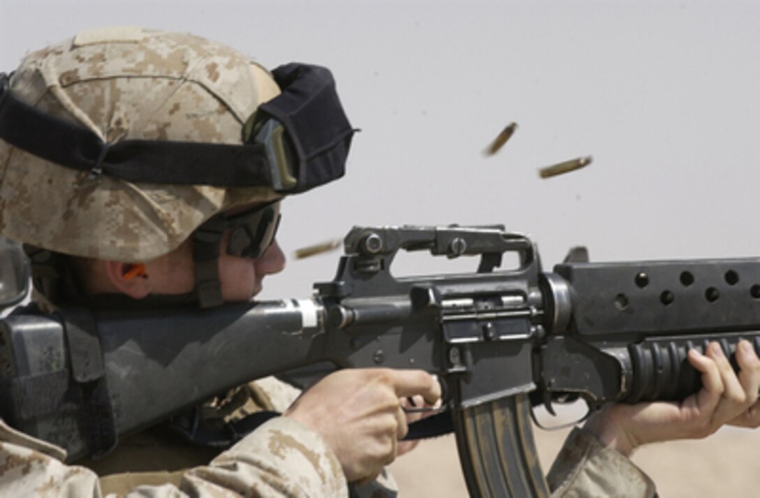 Shell casings fly as a U.S. Marine fires a short round burst on his M-16 rifle at the Udari Range in Kuwait on Aug. 11, 2005. The Interim Marine Corps Security Force Company from Naval Support Activity Bahrain is conducting fast sustainment training exercises that are designed to test the Marines' ability to conduct vehicle checkpoints, entry control points and mobile security patrols. 
