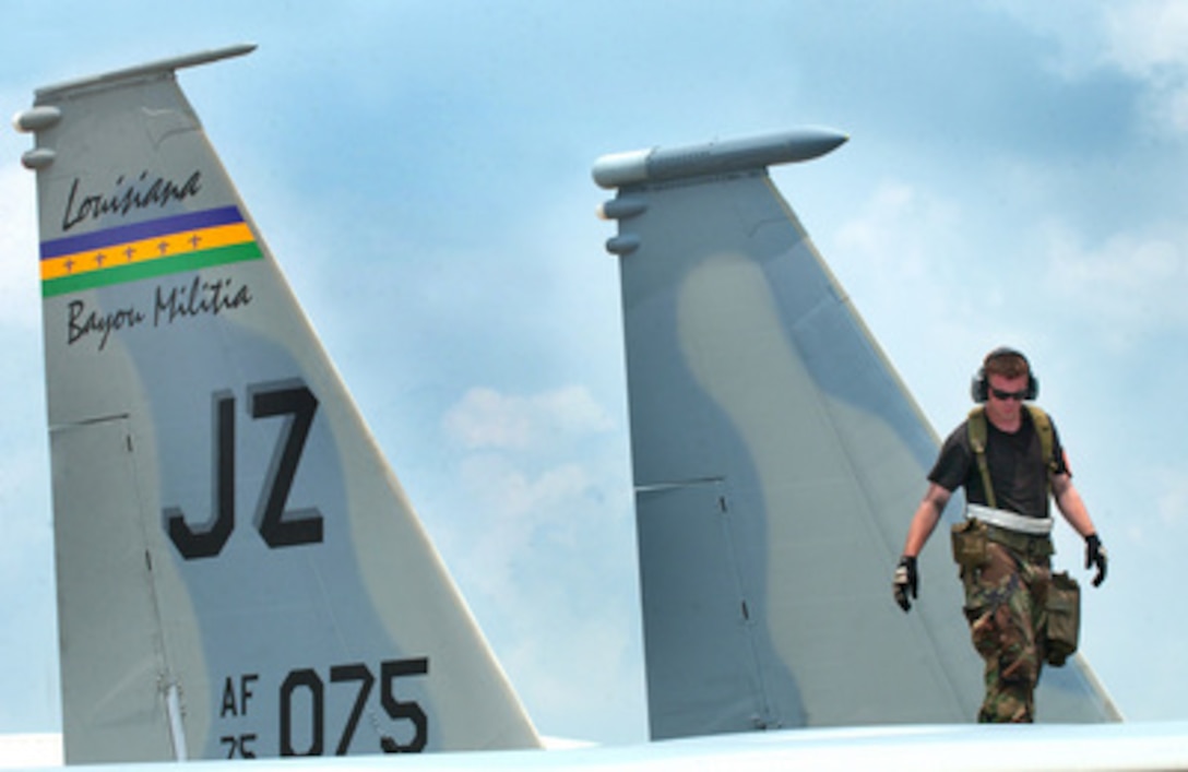 A Louisiana Air National Guardsman of the 159th Fighter Wing Maintenance Group inspects the fuselage of a F-15 Eagle aircraft during an operational readiness exercise at the Air National Guard Combat Readiness Training Center in Gulfport, Miss., on Aug. 12, 2005. 