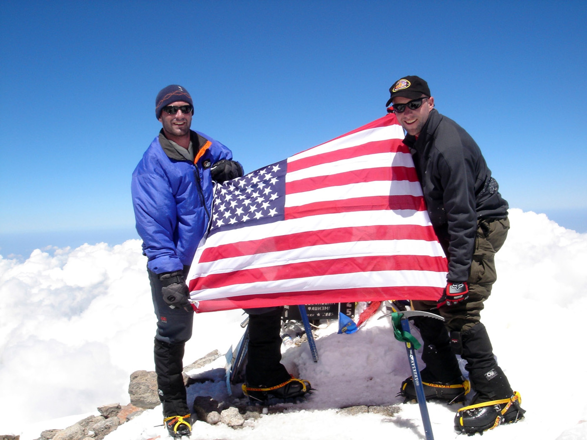 MOUNT ELBRUS, Russia -- First Lt. Mark Uberuaga (left) and Capt. Rob Marshall proudly display the American flag after reaching the summit of Mount Elbrus.  Lieutenant Uberuaga is assigned to the 21st Special Operations Squadron, and Captain Marshall is assigned to the 67th Special Operations Squadron.  Both are from Royal Air Force Mildenhall, England.  (U.S. Air Force photo)