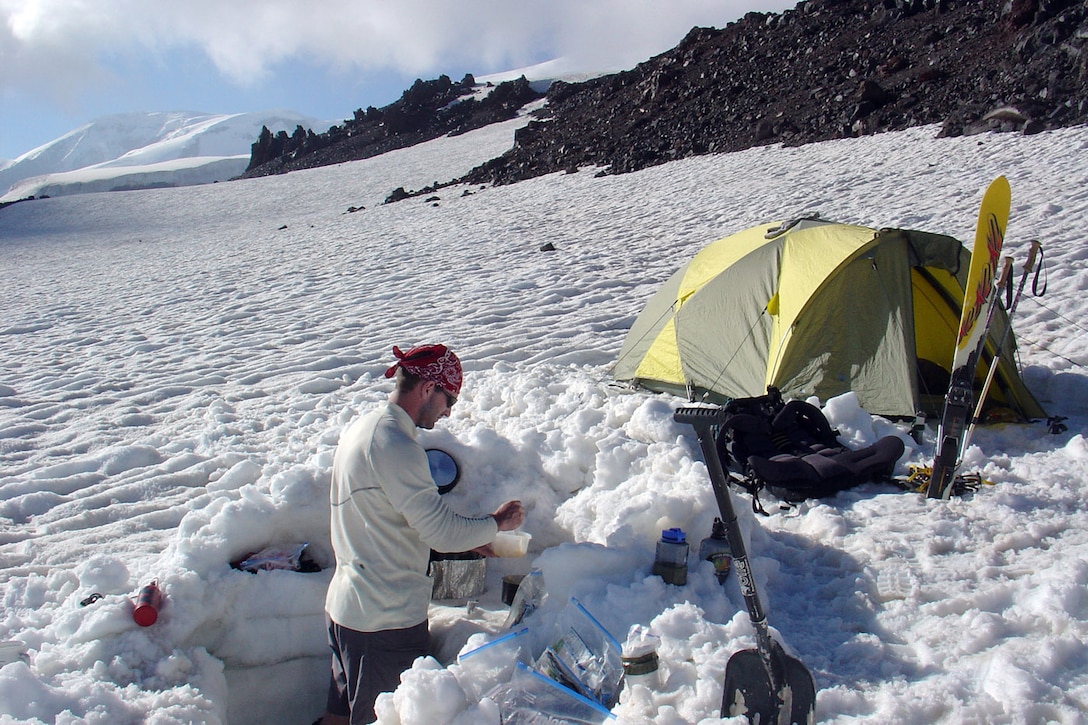 MOUNT ELBRUS, Russia -- First Lt. Mark Uberuaga prepares dinner at his base camp at 12,000 feet on Mount Elbrus.  He and Capt. Rob Marshall reached the summit in four days.  Lieutenant Uberuaga is assigned to the 21st Special Operations Squadron at Royal Air Force Mildenhall, England.  (U.S. Air Force photo by Capt. Rob Marshall)