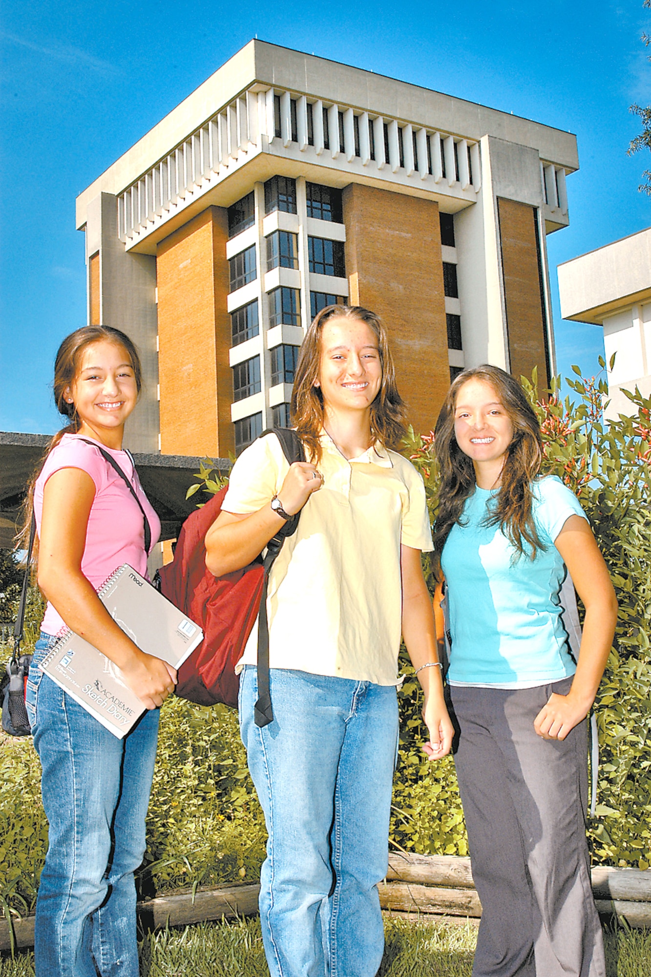 MONTGOMERY, Ala. -- (From left) Sisters Rosannah, 15, Hannah, 17, and Serennah Harding, 14, stand in front of the Auburn University at Montgomery campus.  All three college students are daughters of Capt. Kitchener Harding, an Officer Training School instructor at nearby Maxwell Air Force Base.  The oldest will begin graduate school in the fall.  (U.S. Air Force photo by Frank C. Williams)                       