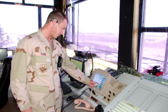 KIRKUK AIR BASE, Iraq -- Senior Airman Ike Munn coordinates inbound aircraft with center radar approach and control.  He is an air traffic controller with the 506th Expeditionary Operations Support Squadron here.  (U.S. Air Force photo by Tech. Sgt. J. LaVoie)