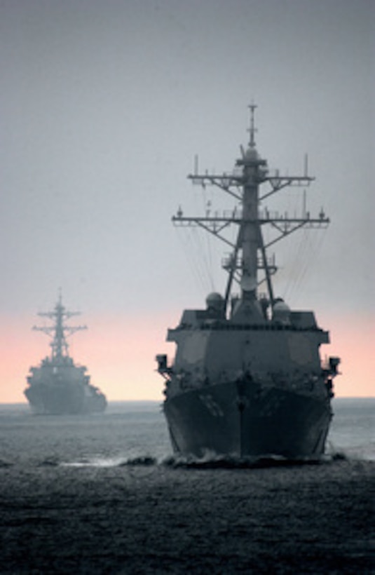 The guided-missile destroyer USS McCampbell (DDG 85) (right) prepares to go alongside the aircraft carrier USS Ronald Reagan (CVN 76) to conduct refueling at sea as the guided-missile destroyer USS Decatur (DDG 73) (left) waits her turn on July 26, 2005. The three ships are training in the Pacific Ocean as the Nimitz conducts Tailored Ships Training Availability. 