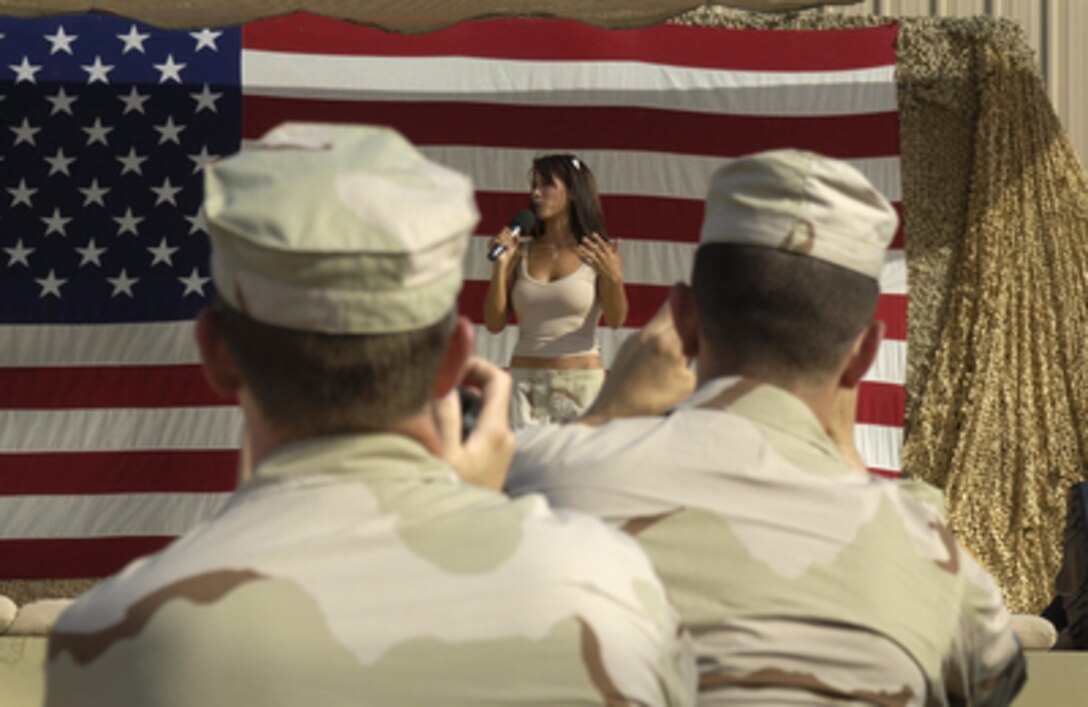 Fox Sports television personality and cover girl Leeann Tweeden talks to the troops at a United Service Organizations show at Camp Arifjan, Kuwait, on Aug. 16, 2005. Tweeden, NFL Hall of Fame member Gale Sayers, comedians Jeffrey Ross and Colin Quinn are accompanying Chairman of the Joint Chiefs of Staff Gen. Richard B. Myers, U.S. Air Force, on a 10-day trip around the world to meet with servicemembers and assess troop morale. 