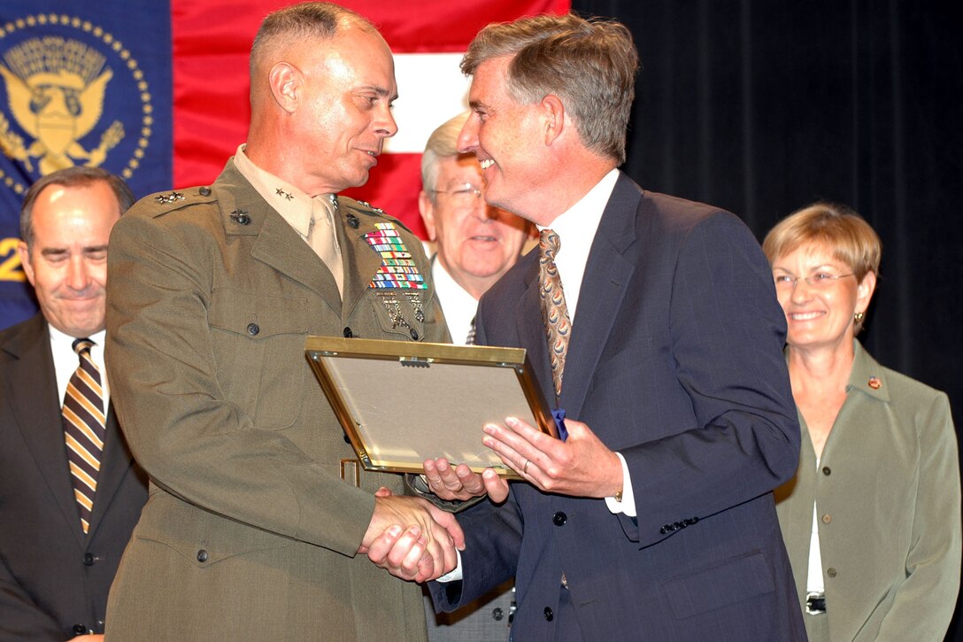 WASHINGTON, D.C. --  Major Gen. Robert C. Dickerson, Marine Corps Base Camp Lejeune?s commanding general, accepts the Commander in Chief?s Annual Award for Installation Excellence from the Honorable Kenneth J. Krieg, the under secretary of defense for acquisition, technology and logistics Wednesday at The Pentagon.  The annual event honors the top installations whose personnel have achieved outstanding and innovative efforts in maintaining a commitment to excellence.