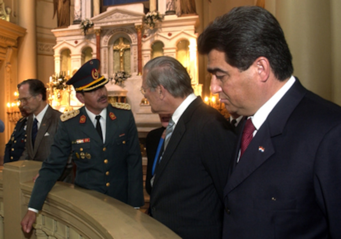 A Paraguayan military officer explains a point of interest in the Pantheon of Heroes to Secretary of Defense Donald H. Rumsfeld (center) and his host Minister of National Defense Roberto Gonzalez in Asuncion, Paraguay, on Aug. 17, 2005. The Pantheon is the site of the Paraguayan Tomb of the Unknown Soldier. Rumsfeld is in Paraguay to meet with Gonzalez and Paraguayan President Nicanor Duarte-Frutos to discuss bilateral military cooperation in the region. 