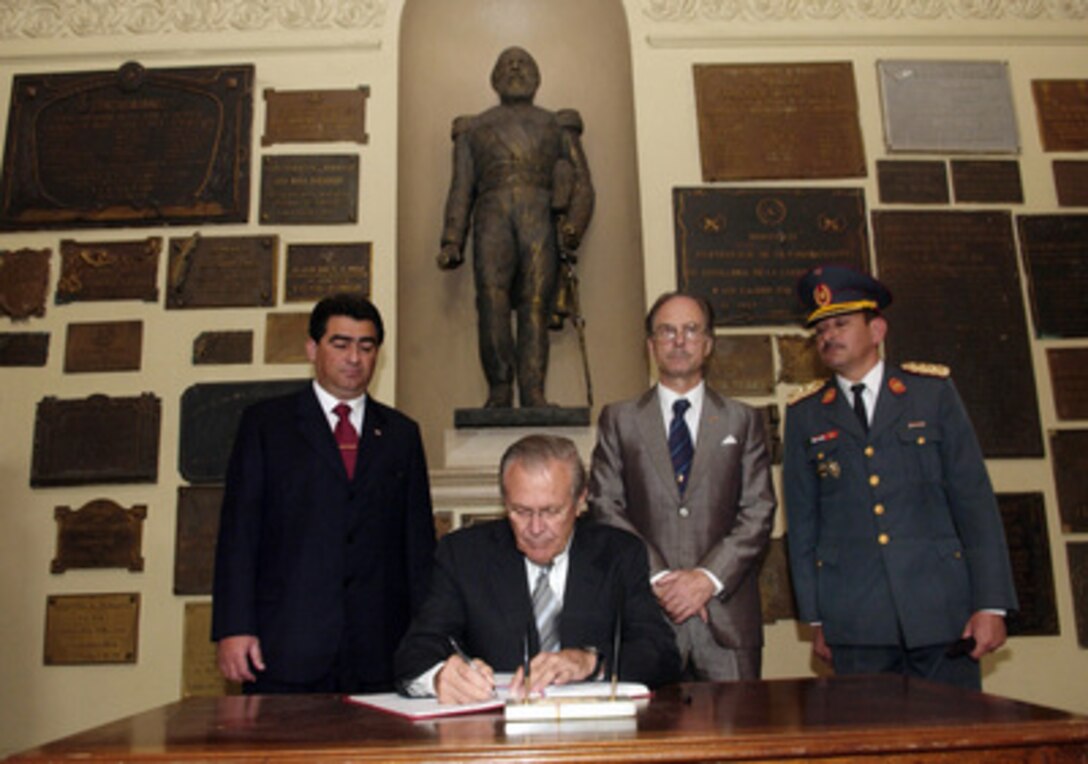 Secretary of Defense Donald H. Rumsfeld (center) signs the dignitary guest book at the Pantheon of Heroes as his host Minister of National Defense Roberto Gonzalez (left) in Asuncion, Paraguay, on Aug. 17, 2005. The Pantheon is the site of the Paraguayan Tomb of the Unknown Soldier. Rumsfeld is in Paraguay to meet with Gonzalez and Paraguayan President Nicanor Duarte-Frutos to discuss bilateral military cooperation in the region. 