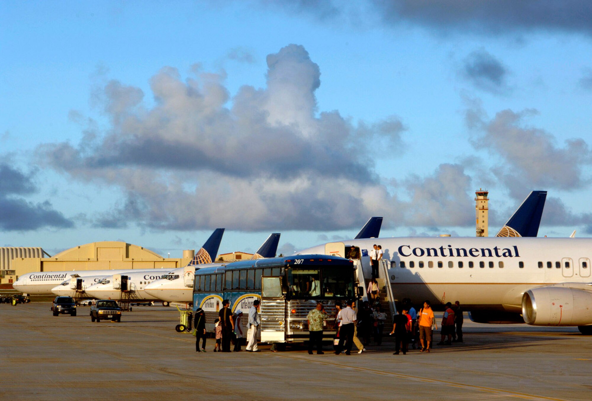 ANDERSEN AIR FORCE BASE, Guam -- More than 800 passengers arrived safely and cleared through customs after their commercial flights were diverted here because of an emergency that temporarily closed Won Pat International Airport, Guam on Aug. 19.  Airmen and local custom agents and authorities worked together to process passengers on eight airliners.  (U.S. Air Force photo by Staff Sgt. Bennie J. Davis III)