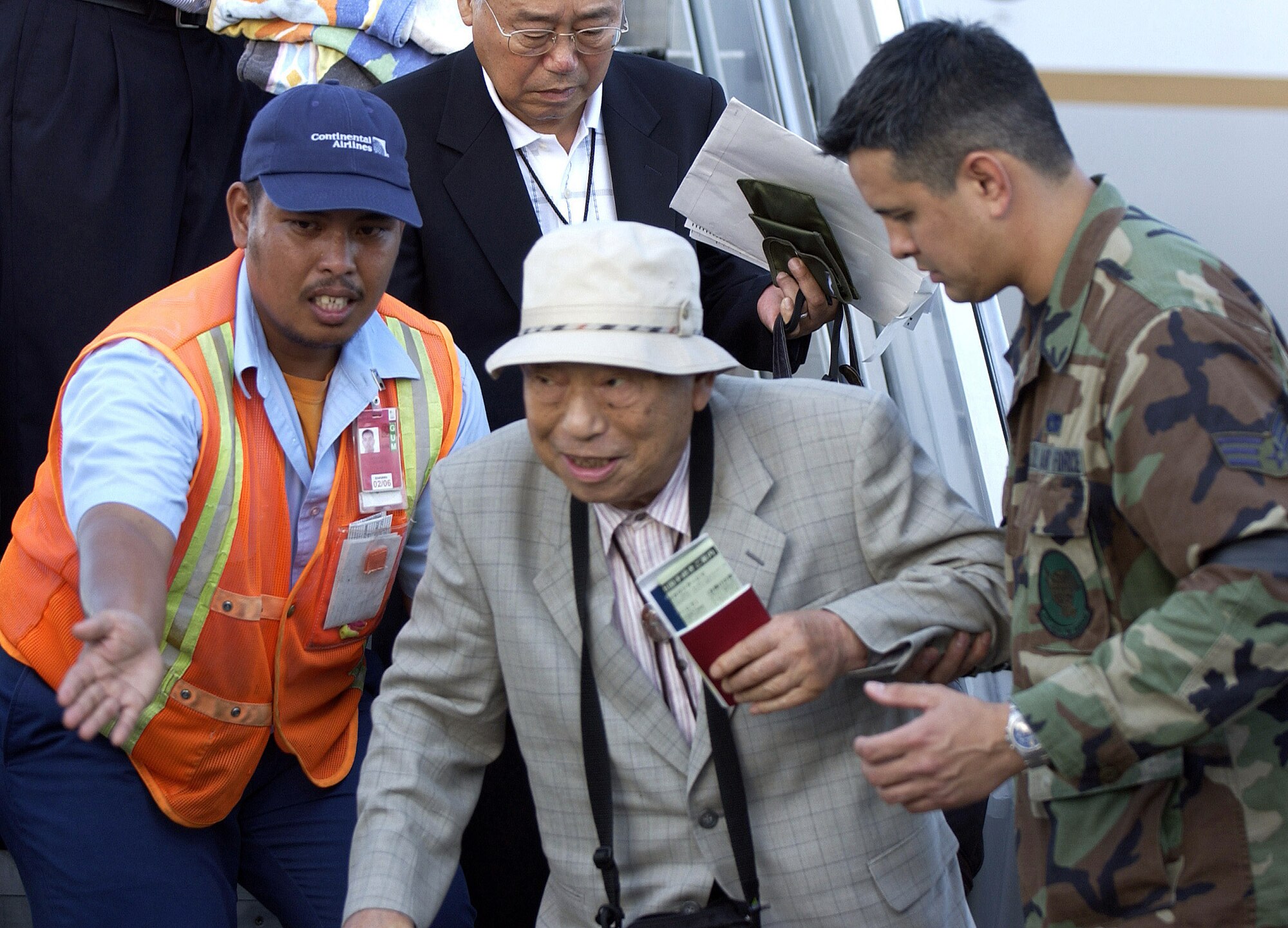 ANDERSEN AIR FORCE BASE, Guam -- Matumoto Seiji departs an aircraft on the flightline here Aug. 19.  Mr. Seiji is just one of more than 800 passengers who arrived safely after their commercial flights were diverted here because of an emergency that temporarily closed Won Pat International Airport.  (U.S. Air Force photo by Airman Miranda Moorer) 