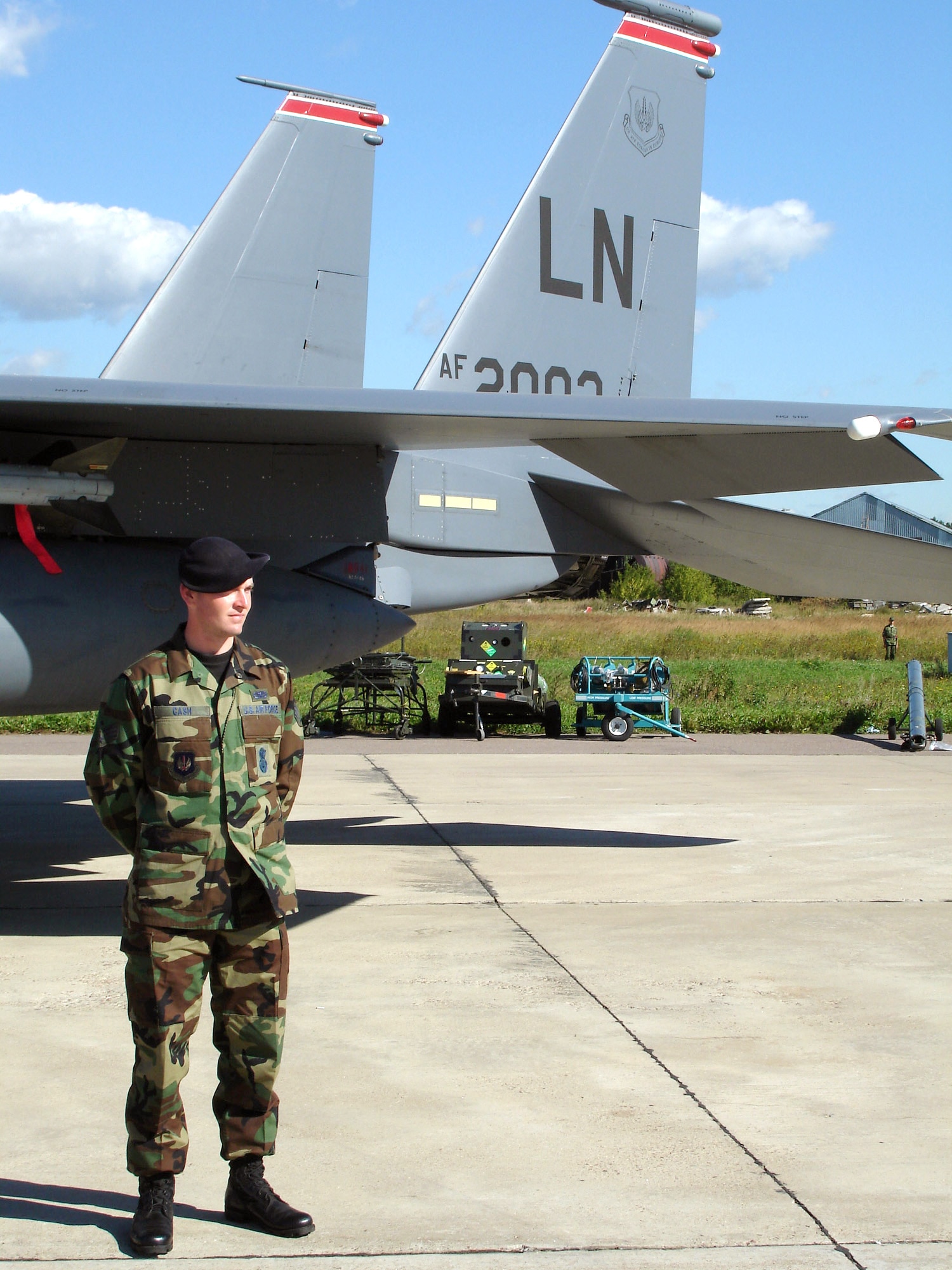 ZHUKKOVSKY, Russia -- Senior Airman Larry Cash stands watch by an F-15E Strike Eagle during the Moscow International Air Show and Space Salon at Ramenskoye Airfield.  Though U.S. security forces Airmen are not armed during the air show, they are responsible for maintaining security of the U.S. aircraft participating in the event.  Airman Hurst is from Royal Air Force Lakenheath, England, and is the 48th Security Forces Squadron security response team leader.  (U.S. Air Force photo by Tech. Sgt. Cindy Dorfner)