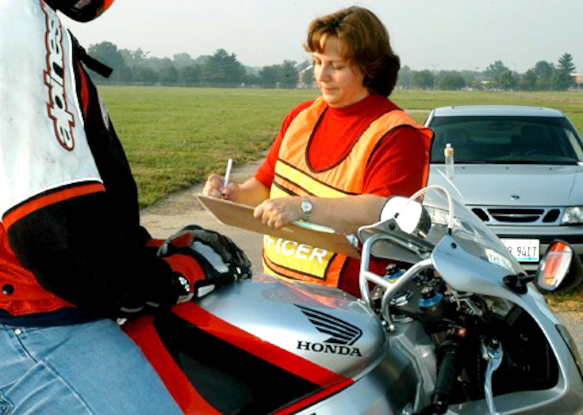 SCOTT AIR FORCE BASE, Ill. -- Marilee Reuter follows a checklist while inspecting a motorcyclist who came through the base gate here recently. The safety office, along with security forces Airmen, conducted the inspections in an effort to lower motorcycle mishaps. Ms. Reuter is the 375th Airlift Wing's ground safety manager. (U.S. Air Force photo)
