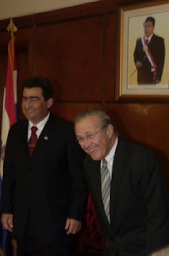 Peruvian Minister of Defense Marciano Rengifo (right) welcomes Secretary of Defense Donald H. Rumsfeld (left) to his office in the Ministry of Defense headquarters in Lima, Peru, on Aug. 18, 2005. Rumsfeld is in Lima to meet with Rengifo and Peruvian President Alejandro Toledo to discuss bilateral military cooperation in the region. 