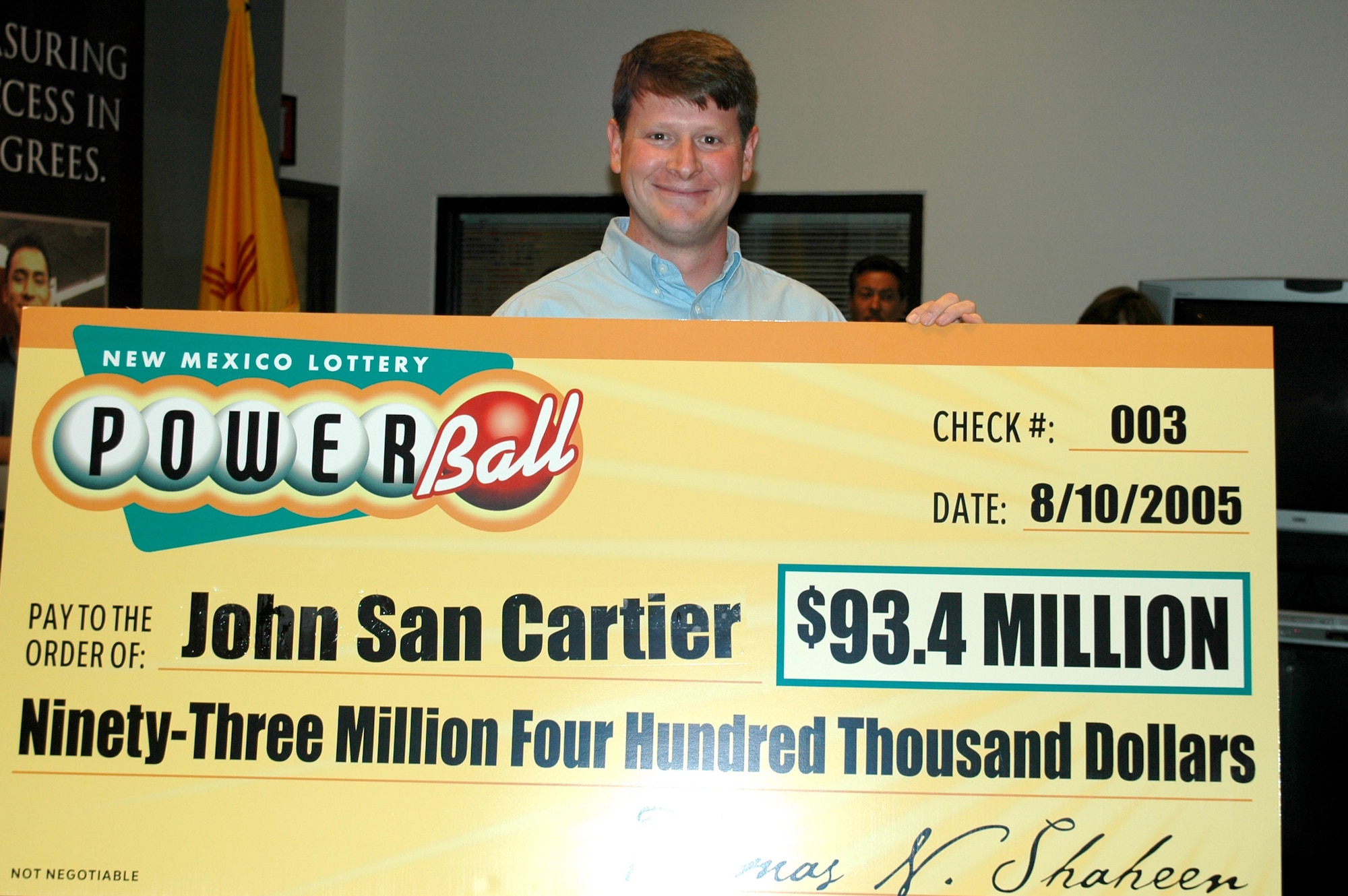 KIRTLAND AIR FORCE BASE, N.M. -- Master Sgt. John San Cartier holds his winning lottery check for $93.4 million. He is a special operations loadmaster instructor with the 58th Training Squadron here. (U.S. Air Force photo)