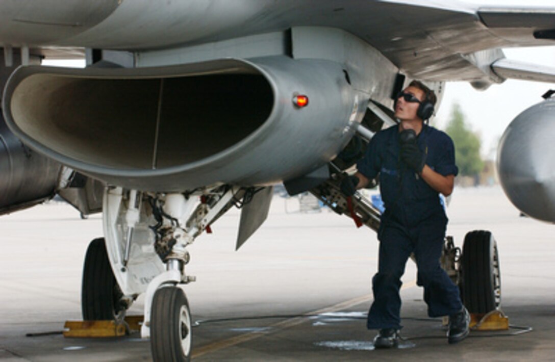 Air Force Senior Airman John Gause conducts his preflight checks on an F-16 Fighting Falcon during routine flight operations at Luke Air Force Base, Ariz., on Aug. 9, 2004. Gause is an F-16 crew chief with the 62nd Aircraft Maintenance Unit, 56th Fighter Wing at Luke. 