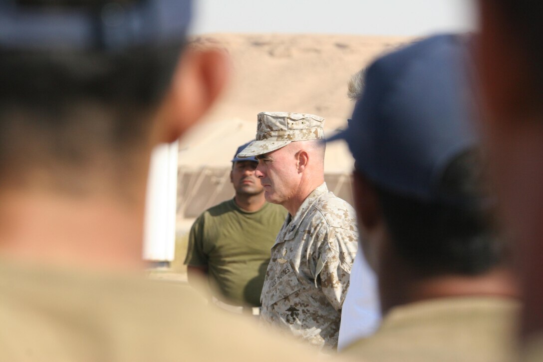 AL ASAD, Iraq - Guest of honor and guest speaker, Col. Kent W. Bradford, the division liaison officer for the forward deployed 2nd Marine Aircraft Wing, offers words of encouragement to the police academy advanced course graduates Aug. 24.  Bradford emphasized how vitally important it is that Iraqi men, like the graduates, commit themselves to ensuring the security of Iraq.