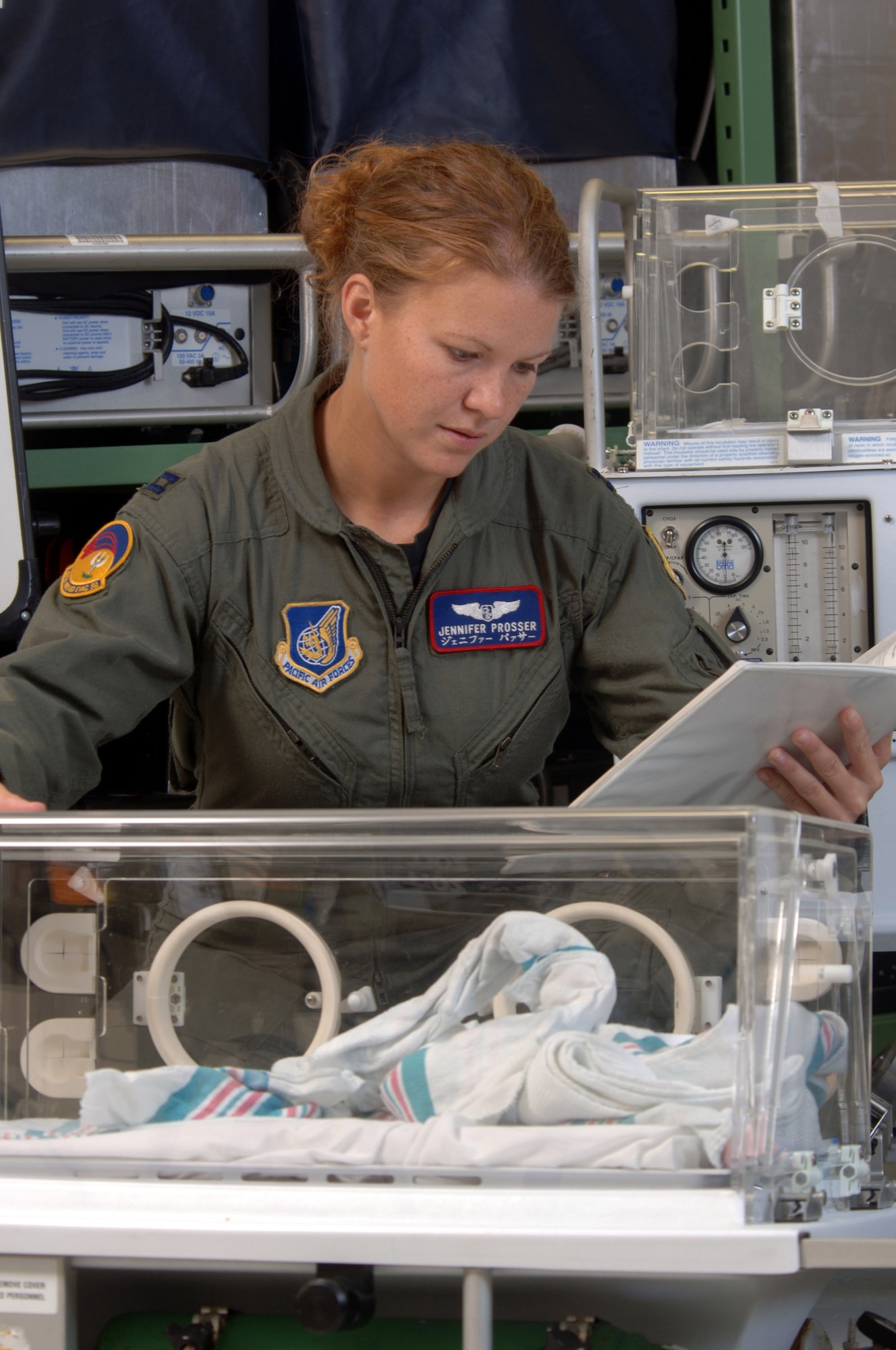 KADENA AIR BASE, Japan -- Capt. Jennifer Prosser checks a neonatal transportation system before a mission here.  The mission of the 18th Aeromedical Evacuation Squadron is to provide a flexible, seamless and responsive system capable of prompt and appropriate patient movement.  Captain Prosser is a flight nurse with the squadron.  (U.S. Air Force photo by Master Sgt. Val Gempis)