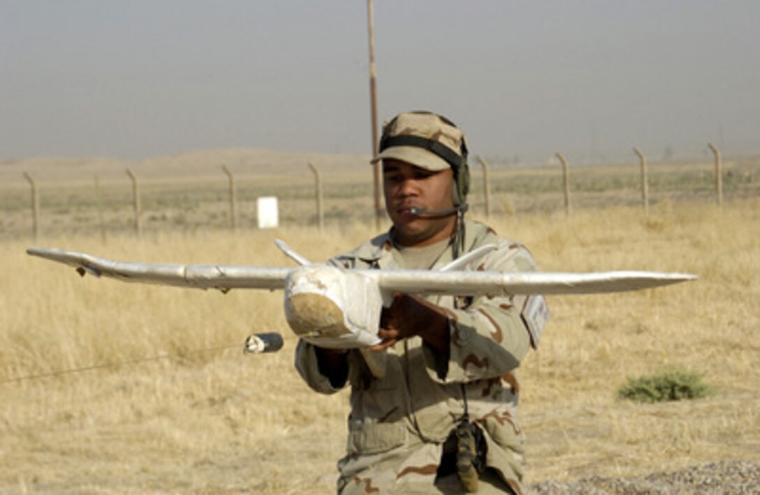 U.S. Air Force Senior Airman Johnathan Hobbs pulls a Desert Hawk surveillance plane back in preparation for launch from Kirkuk Regional Air Base, Iraq, on Aug. 23, 2005. The Desert Hawk flies over 30 missions each month recording still and video images for intelligence purposes. Hobbs is deployed to Kirkuk from Moody Air Force Base, Ga. 
