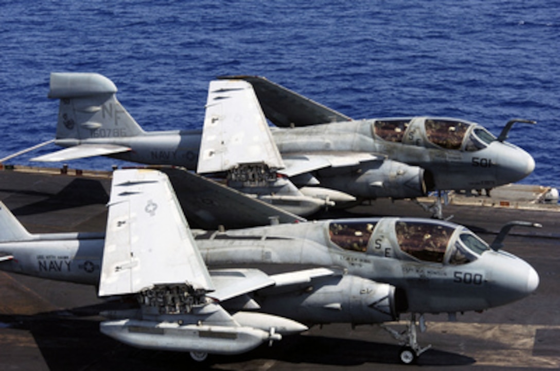 Two Navy E/A-6B Prowlers sit with wings folded as they wait to be catapulted off the flight deck of the USS Kitty Hawk (CV 63) on Aug. 18, 2005. The all weather Prowler provides protection for strike aircraft, ground troops and ships by jamming enemy radar, electronic data links, communications and obtains tactical electronic intelligence within the combat area. 