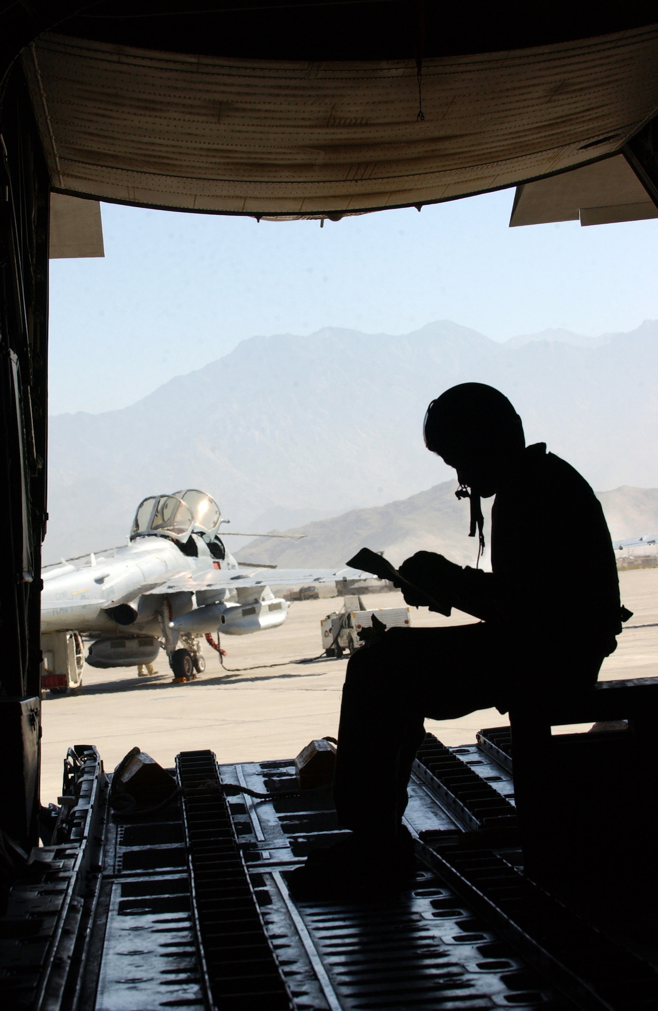 BAGRAM AIR BASE, Afghanistan -- Senior Airman Johnny Rivera prepares for a C-130 Hercules mission that supplied ground troops with equipment needed.  He is a loadmaster with the 317th Aircraft Maintenance Squadron and is deployed from Dyess Air Force Base, Texas.  (U.S. Air Force photo by Airman 1st Class Desiree L. Hayden)