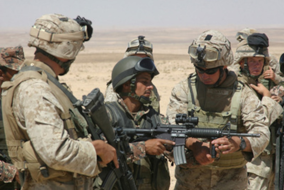 U.S. Marines instruct a Jordanian soldier on how to fire a M-4 carbine rifle during live-fire training at Al Qatranah Range in Jordan, on Aug. 16, 2005. Marines of 2nd Battalion, 8th Marines, 26th Marine Expeditionary Unit (Special Operations Capable), are conducting several types of bilateral training with the Jordanian Army. 