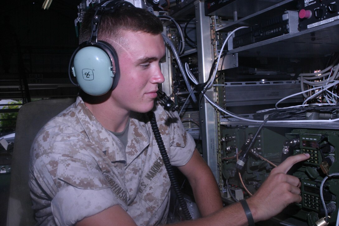 Lance Cpl. Joshua P. Johnson, 19, a field radio operator, Headquarters, 3rd Marine Regiment, Communications, Marine Corps Base Hawaii, Kaneohe Bay, tests out the controls in the new M2C2 prototype.