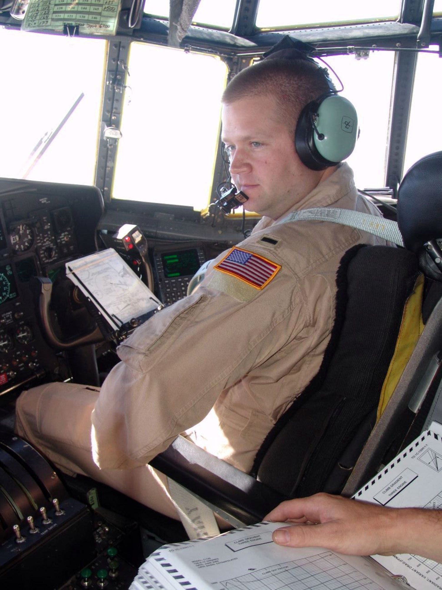 SOUTHWEST ASIA -- Co-pilot 1st Lt. Joseph McCormick relays information with aircraft commander Maj. Jaye Stepp before an airdrop mission over Afghanistan.  Major Stepp and Lieutenant McCormick are assigned to the 738th Expeditionary Airlift Squadron at a forward-deployed location and are deployed from the North Carolina Air National Guard's156th Airlift Squadron.  (U.S. Air Force photo by Staff Sgt. Carlos Diaz)
