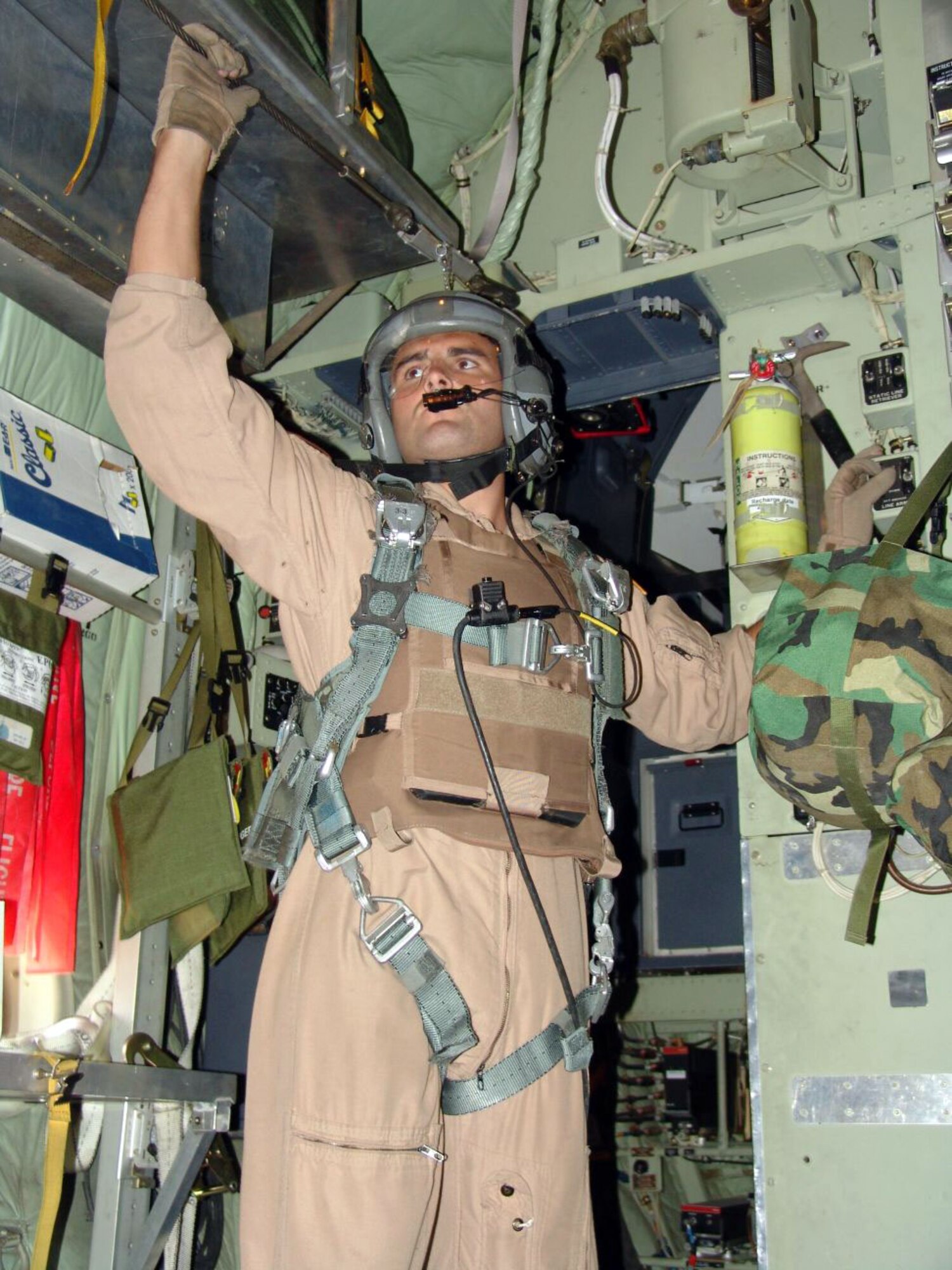 SOUTHWEST ASIA -- Staff Sgt. Chad Wells prepares to open the ramp before an airdrop mission over an Afghanistan drop zone.  Sergeant Wells is a C-130 Hercules loadmaster with the 738th Expeditionary Airlift Squadron at a forward-deployed location.  He is one of six Air National Guard aircrew members from the North Carolina Air National Guard's 156th Airlift Squadron deployed here.  (U.S. Air Force photo by Staff Sgt. Carlos Diaz)
